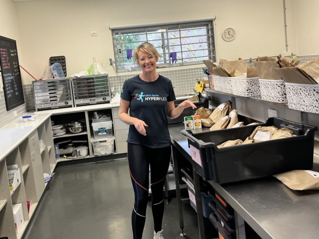 Ciara posed for a picture in a school kitchen making packed lunches.