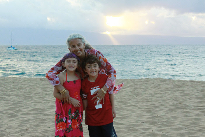 Connie with her kids on the beach during her 5-year milestone trip back to Maui.