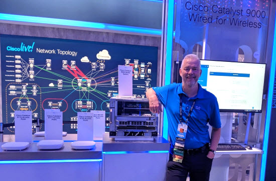 Peter at Cisco Live US 2019, standing behind the Cat 9k — technology near and dear to his heart.