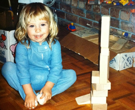 Madeline at age 2 working on one of her many block towers.