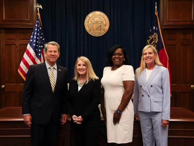 Kim was recognized by Georgia Governor Kemp (far left) for her pro bono efforts in the state. 