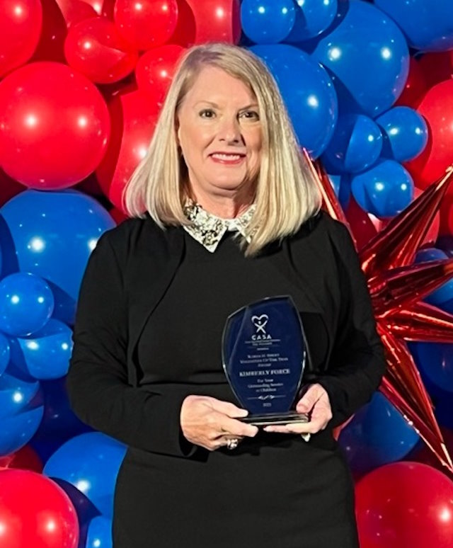 Kim accepts the State of Georgia CASA of the Year Award..