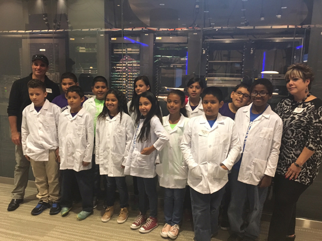 Students properly dressed in lab coats, visit the Cisco office in Richardson, Texas, to learn how a future in technology can shape their lives.