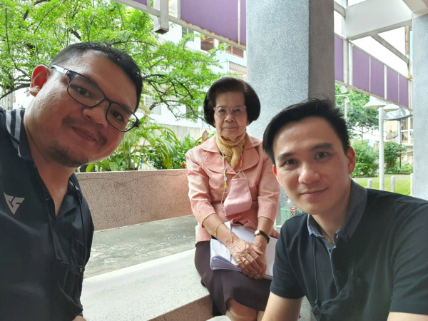 Diff (far left) snaps a selfie with the school’s principal and a fellow volunteer.