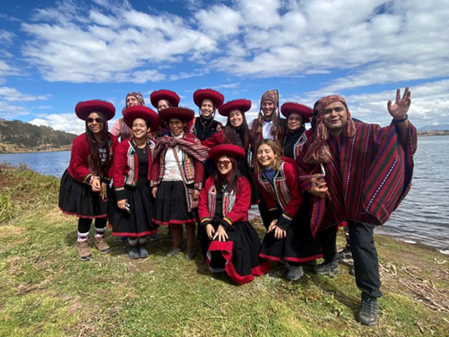 Group photo in front of a body of water.