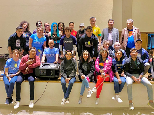 Group photo of Sleep Out participants indoors.