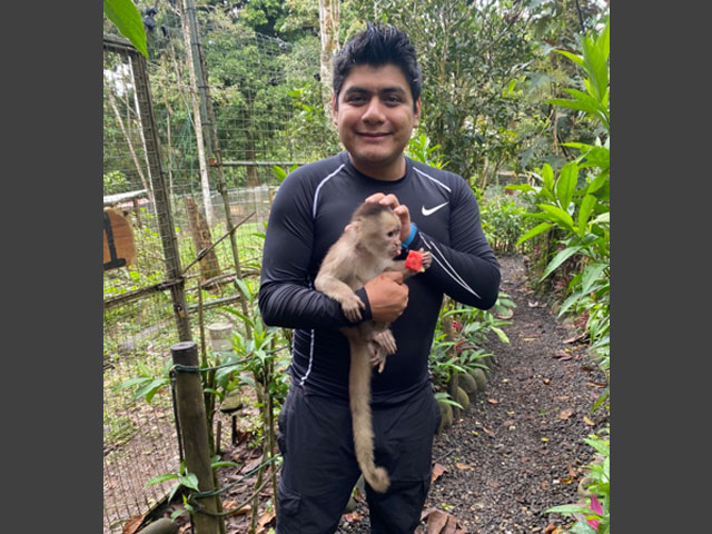 Jair holding a small monkey.