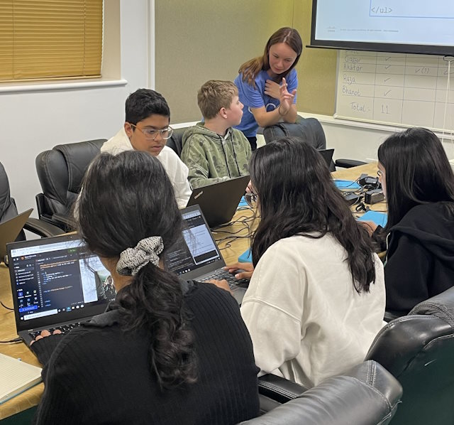 Emily, a Cisco volunteer, teaches students how to code  HTML.