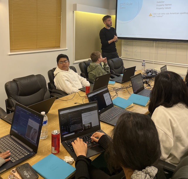 Austin, one of Cisco’s volunteers, teaches students how to write CSS.