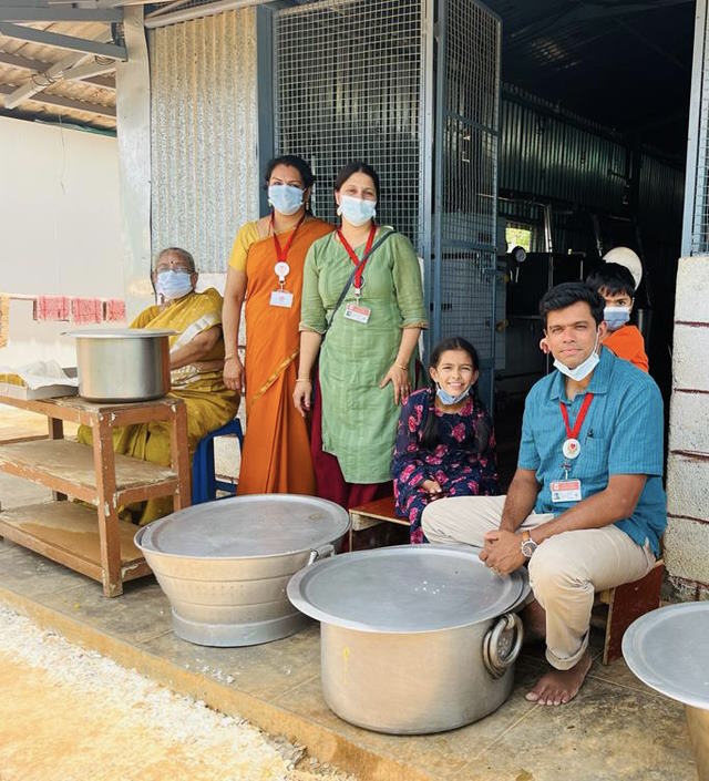 Aditya  and his family volunteering for lunch service at the hospital construction  site.