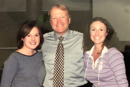 Michelle (far right) poses with former Cisco CEO John Chambers in 2002.