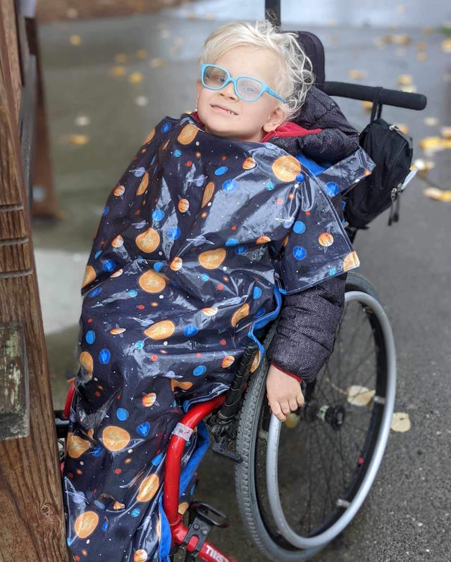 Ford in his wheelchair wearing his custom blanket.