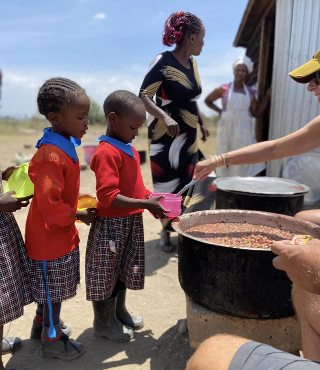 Kenyan children line up to receive lunch.