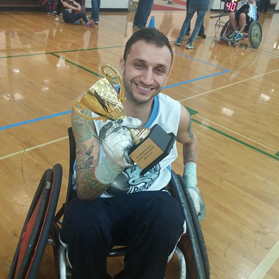 Yianni with his winning trophy at the Akron Rhino Rumble Wheelchair Rugby Tournament.