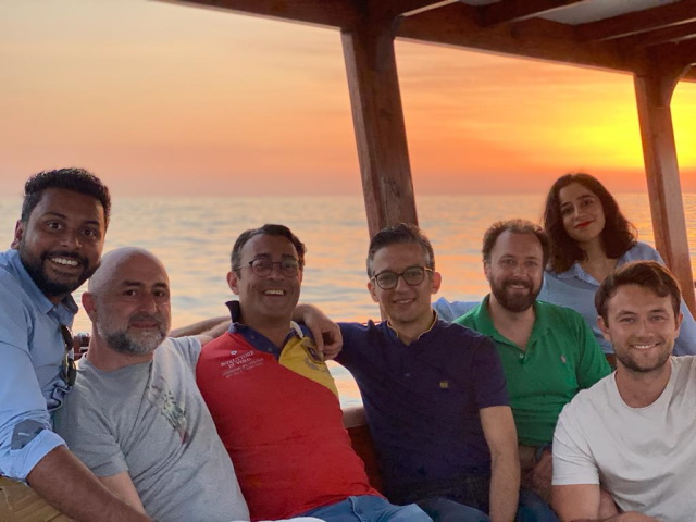 Layel and  her colleagues on a boat at sunset.