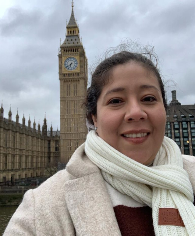 Feliza Lopez stands in front of the Big Ben clock tower in London.
