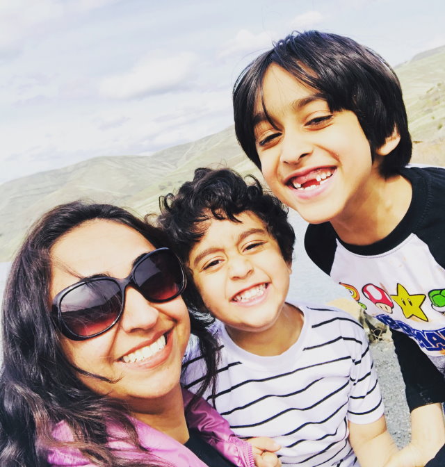 Huma with her two boys Hamza, 5 (left), and Abdullah, 8
        (right).