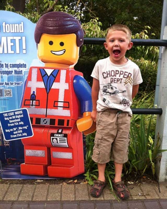 George standing next to The Lego Movie character