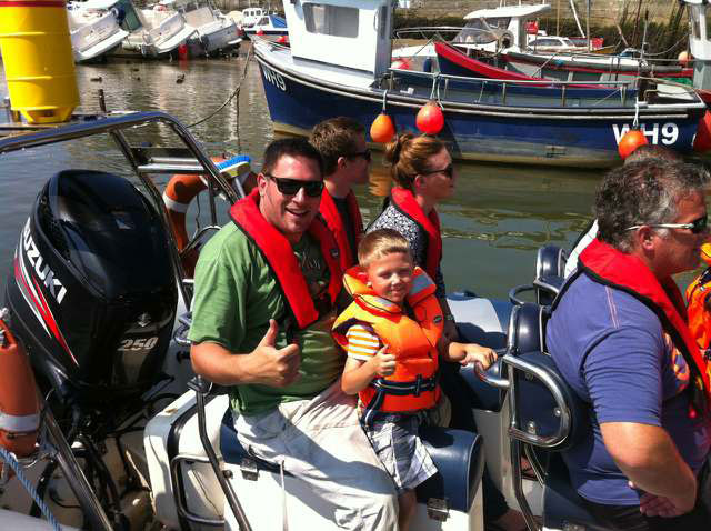 George enjoying  going out on a rib boat with his dad, Simon. 