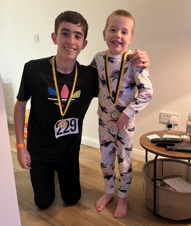 Jack and Thomas embrace while wearing medals