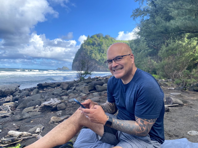 TK Keanini at the beach smiling