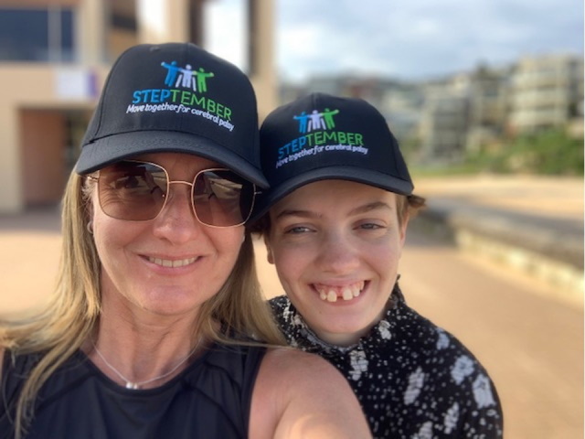 Kerry and her daughter pose for a selfie while wearing STEPtember hats.