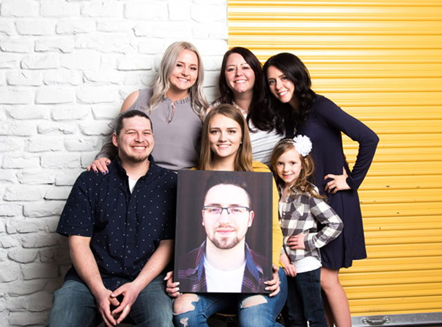 Candace, her girls, and son in law with a picture of Jamin.