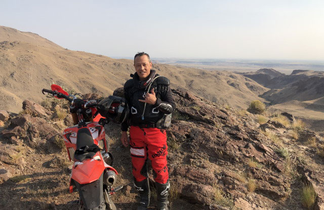 Pono and his bike in a mountain