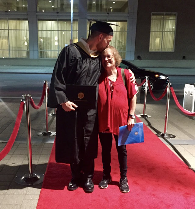 Randy wearing a cap and gown with his mom.