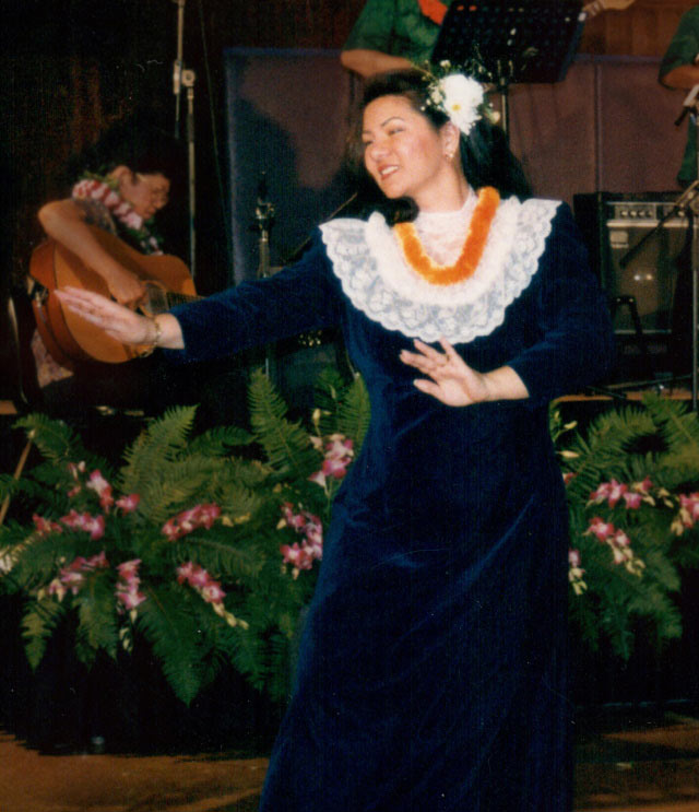 Yvonne performs in a hula competition with her hula school, Hula Hālau O Piʻilani, in 2000.