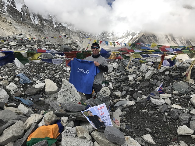 photo of David waving a Cisco t-shirt on Mt. Everest